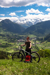 Fototapeta premium Man mountain biking in swiss alps valley