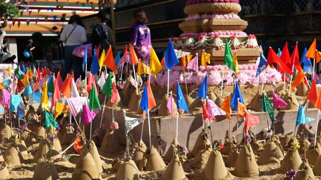 People make small sand pagodas in temples during the Songkran Festival (Thai New Year). This is a traditional activity in the old days to bring sand to the temple, for example, to build pagodas. 