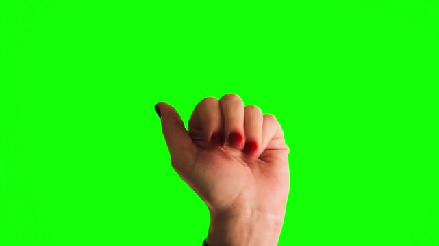 Close-up of a female hand making a come here, gesture in front of a green screen background. Shot for chroma key use to easily replace the background. Concept of calling, inviting, beckoning