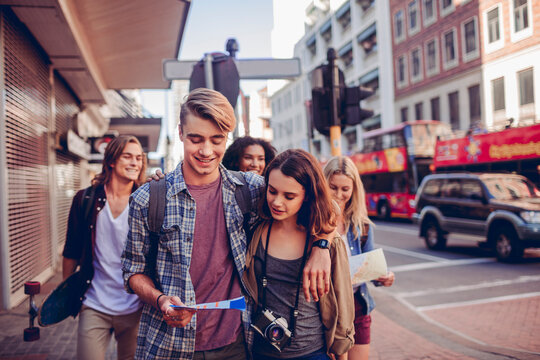 Group of young friends sightseeing in city street