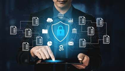 Businessman Using Tablet for Cybersecurity Management with Digital Lock and Data Protection Icons...