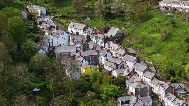Aerial view of Clovelly Village and Harbour which is a historic 13th-century stone quay located in a privately owned, picturesque North Devon fishing village. Scenic Drone Exploration of village.