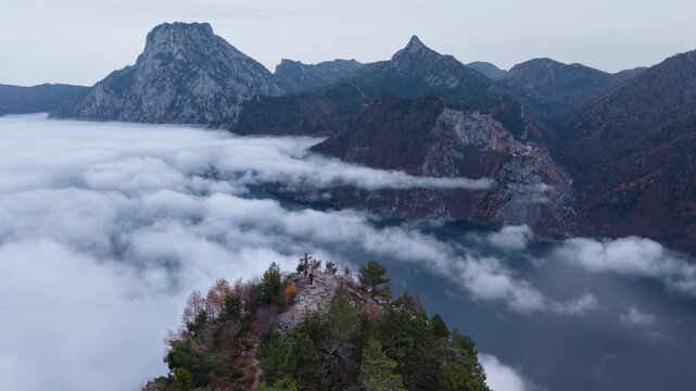 Epic Aerial Reveal of Mountin Summit Cross Above a Se of Clouds