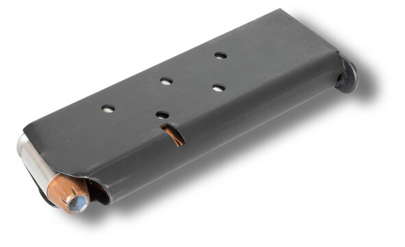 Shadow. below a 1911 semi-auto pistol magazine with hollow point cartridges