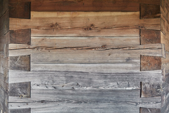 Beautiful close-up of a wooden wall with an ornate corner joint.