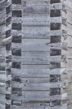 Beautiful close-up of a wooden wall with an ornate corner joint.