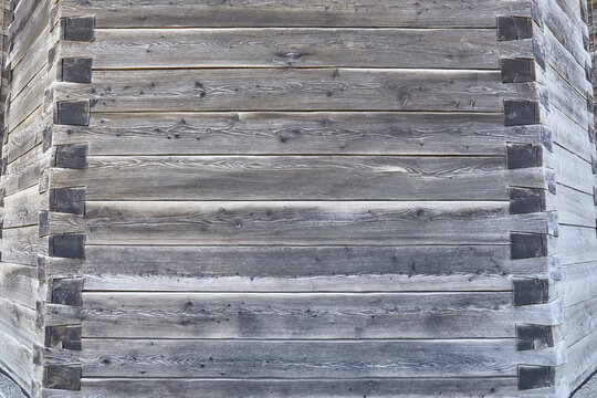 Beautiful close-up of a wooden wall with an ornate corner joint.