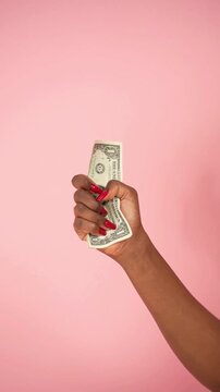 Close Up of a Confident Woman Holding a Stack of Money and Scales of Justice Symbolizing Financial Empowerment Equal Pay Day and Gender Pay Gap Awareness for Business and Wealth Concept in 4k
