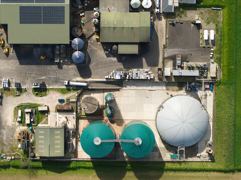 Aerial view of the Bioganix industrial facility featuring anaerobic digestion tanks, solar panels on rooftops, and storage silos in Brigg, England, United Kingdom.