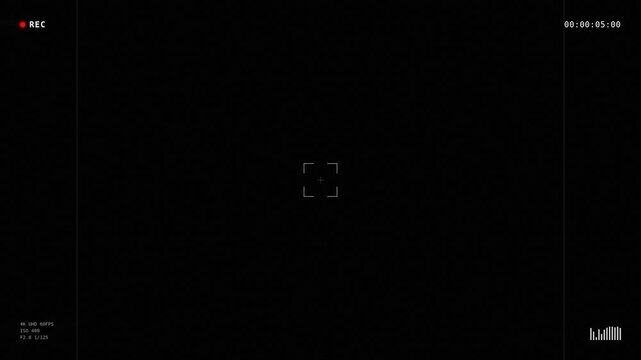 A dark screen displaying a recording interface with a red indicator light and focus brackets