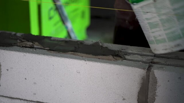 Professional Mason Laying Mortar for Brickwork Foundation
