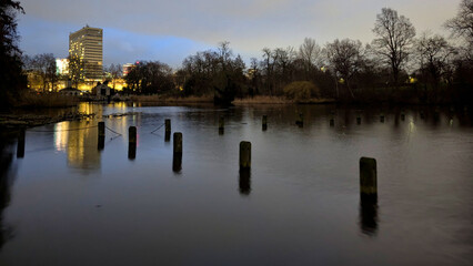 Fototapeta premium London, UK; 13th February 2026: Night view of the Serpentine in Hyde Park with the illuminated Royal Lancaster London hotel rising in the background, reflected on the still water
