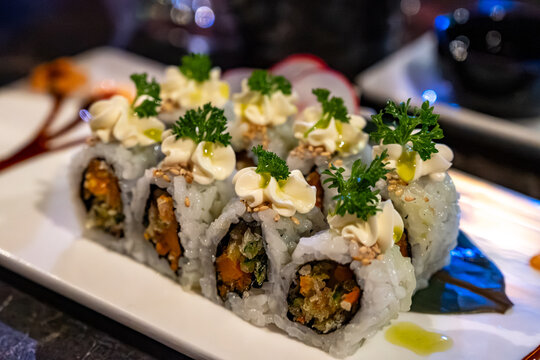 Perfect decorated Japanese sushi rolls with crunchy fried tempura vegetables, vegetarian sushi, vasabi and mayonnaise