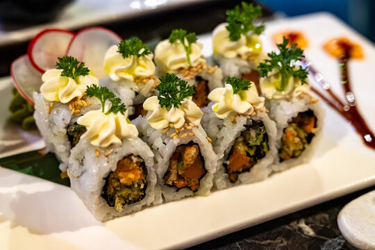 Perfect decorated Japanese sushi rolls with crunchy fried tempura vegetables, vegetarian sushi, vasabi and mayonnaise