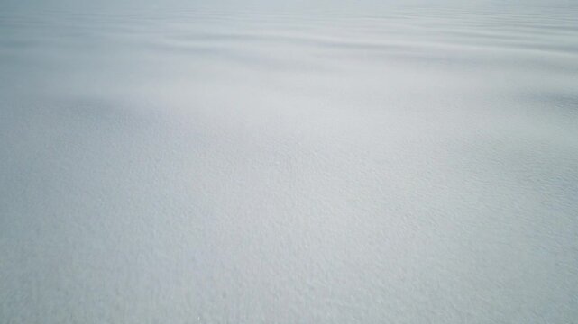 Abstract snow texture background, soft white frozen landscape, winter surface pattern.