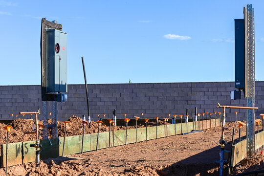 Commercial building construction site with concrete masonry walls, structural columns and foundation work, illustrating new development, building construction, and site preparation