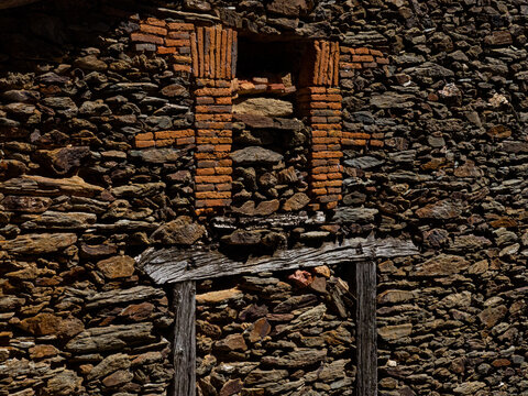 Old stone and brick wall featuring a rustic lintel