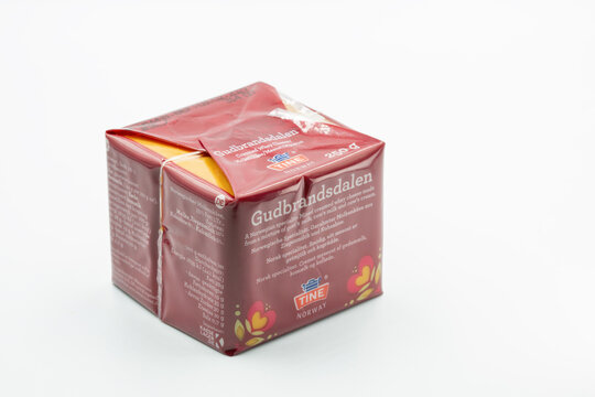 Gudbrandsdalen Norwegian brown caramel cheese block packaging closeup on white.
