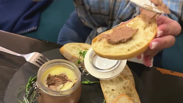 Gourmet Spreading Pate spread on bread with microgreens and baguette closeup appetizer serving Spreading Pate On a piece of Bread. High quality 4k footage