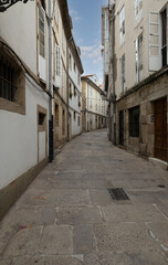 Fototapeta premium Quiet Narrow European Alley With Old Stone Buildings And Cobblestone Street In Historic Town