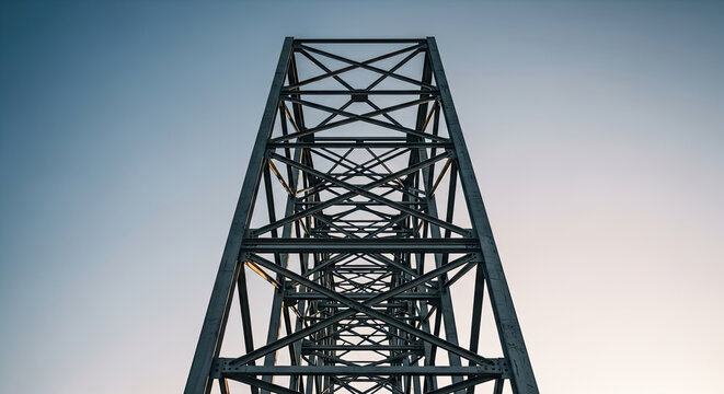 Abstract low-angle view of a robust grey metal truss bridge structure showcasing intricate geometric patterns against a clear blue and warm gradient sky symbolizing strength and modern engineering.
