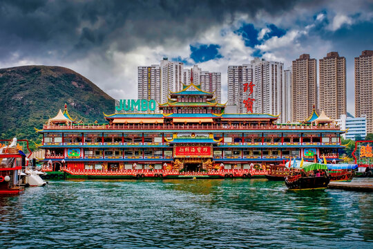 Jumbo Floating Restaurant in Aberdeen Harbour, Hong Kong, China, with city towers and hillside backdrop across the water.