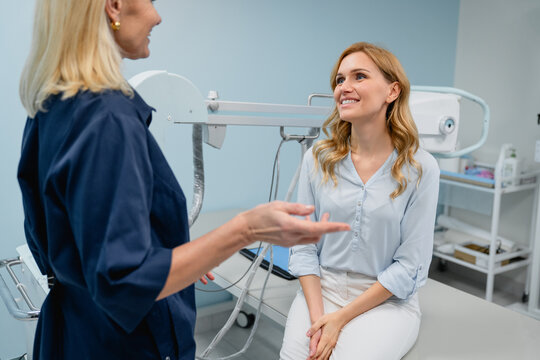 Female doctor talking with patient in X-ray room, professional medical consultation in radiology department, healthcare communication and diagnostic medicine concept