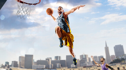 Basketball. Basketball player practice on a basketball court in the big city. A beautiful landscape is in the background. © 103tnn