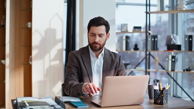 Business owner writing notebook browsing laptop data sitting office closeup.
