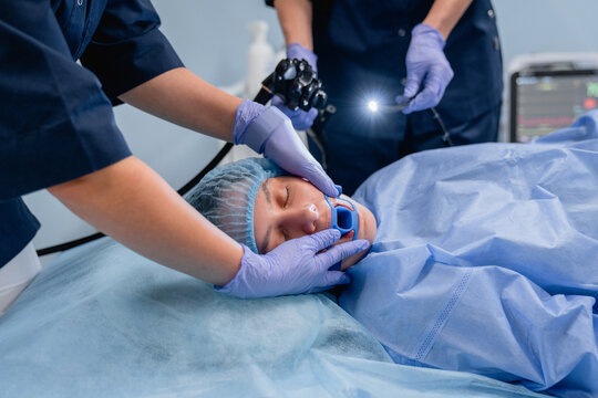 Medical doctors and woman patient during endoscopy procedure in clinic, gastroscopy bronchoscopy and otolaryngology examination, healthcare service and diagnostics