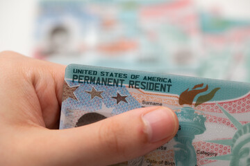 Close-up view of United States Permanent Resident cards stacked together. Concept of immigration,...