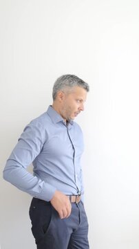 Impatient mature man tapping wrist pointing to watch time gesture