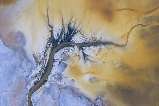 Aerial view of the abstract mineral patterns and branching salt crusts of Searles Lake in the Mojave Desert San Bernardino County, California, United States.