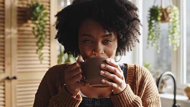 Woman drinks coffee at home.