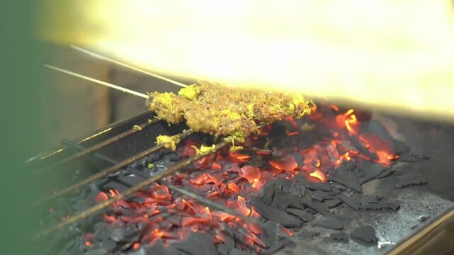 Sate klatak, Indonesian grilled goat skewers over hot charcoal, smoky street food from Yogyakarta cooked over open fire.