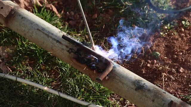 Welding process with bright sparks and smoke