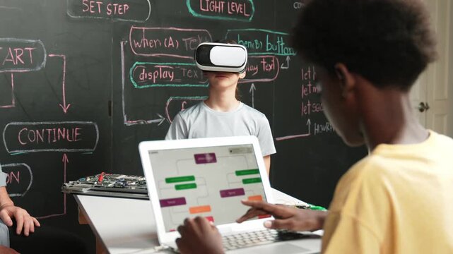 African boy programming system while caucasian girl enter metaverse while sitting at blackboard with engineering code written.high school girl wearing VR or headset in STEM technology. Edification