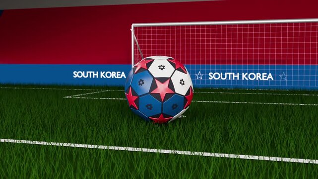 Dropping soccer ball rolling across pitch from thin stand, settling before goal with SOUTH KOREA