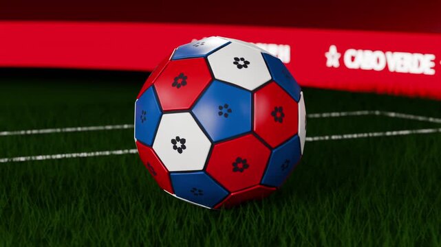 Spinning soccer ball descending to turf, settling while camera pullback showing red band for TV