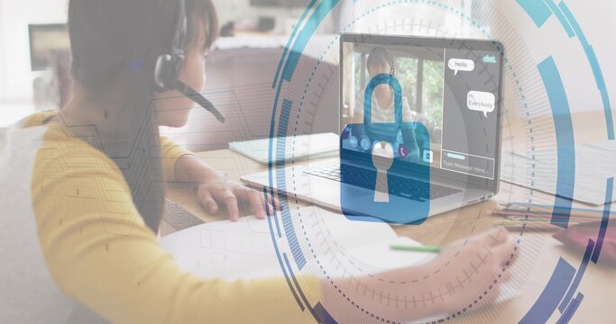 Writing Chinese girl wearing yellow-top and headset at home with laptop, padlock-HUD, copy space