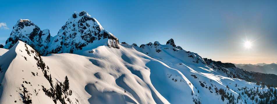 Snow-Covered Mountain Peaks at Sunrise in British Columbia, Canada &mdash; Winter Alpine Landscape Panorama