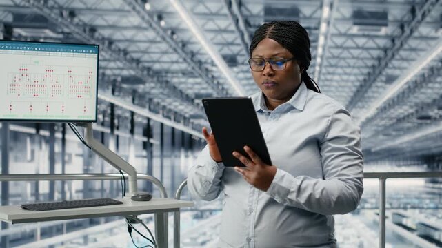 Businesswoman in microchip factory using AI model to develop innovative technology roadmap. African american female manager uses deep learning to develop high tech semiconductors, camera B