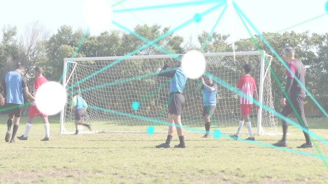 Soccer attacker driving ball into box, defenders crowding net, animated teal lines preventing goal