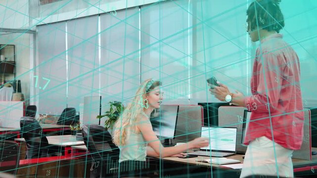 Woman reading docs while male peer coming and showing phone, teal grid overlaying office data