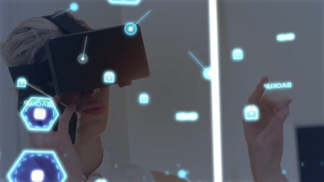 Woman using VR HMD raising finger and initiating AR interface holding phone, navigating hex nodes