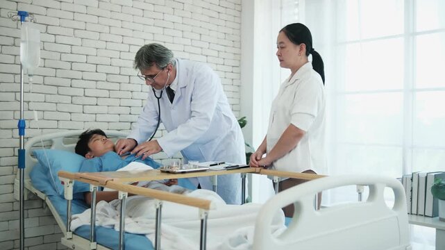 Professional White doctor visits, exams, and checkups sick Asian patient boy in pediatric hospital ward, child illness healthcare consultation and medic physician, diagnosis advice to parent worried.