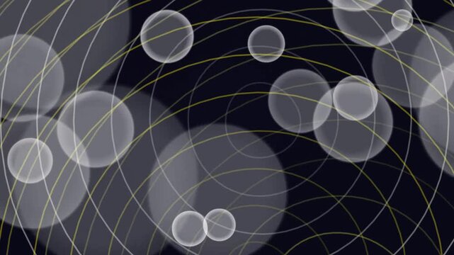Abstract animation with expanding yellow circles and white bokeh spheres.