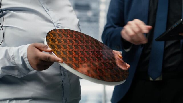 Analyzing electronic components, silicon wafer and researchers evaluating advanced microchip prototype. developing new hardware, semiconductor substrate close up and workers in smart factory, camera B
