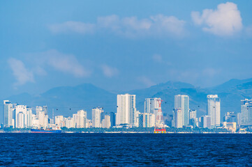 Obraz premium Panorama of Nha Trang city in Vietnam. View of resort town with skyscrapers of hotels by sea in Asia on summer day