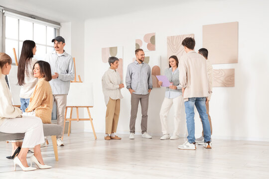 Group of people at exhibition in art gallery